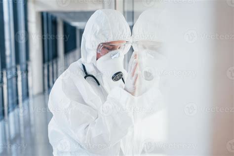 Feels bad and sick. Female doctor scientist in lab coat, defensive ...