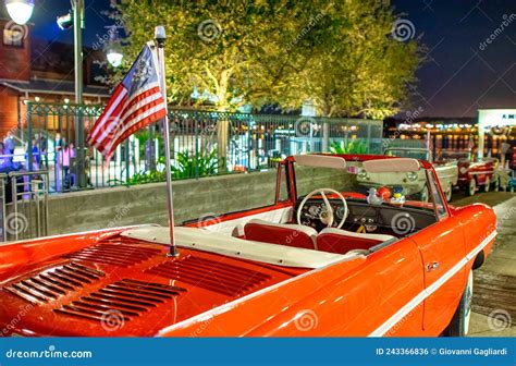 Vintage Red Car Parked At Night Near The City Center Editorial Photo