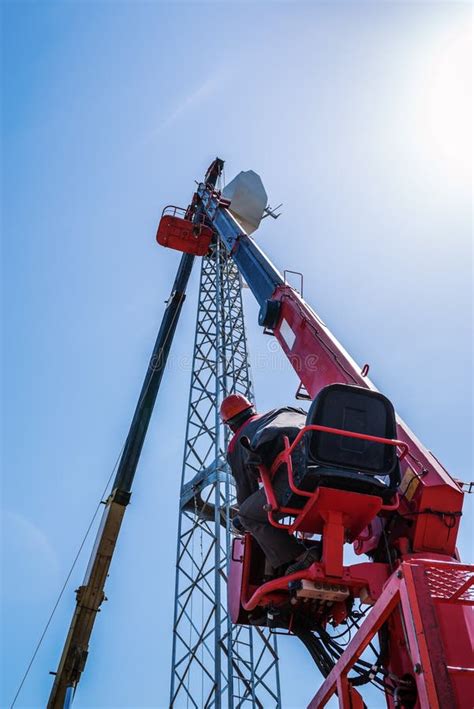 Worker Operator Of The Aerial Platform At The Workplace Installation