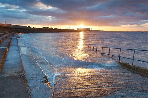 Grimsby Docks At Sunset Viewed From The Seawall At Cleethorpes