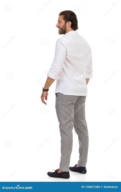 Rear Side View Of Elegant Man Standing And Looking Away Stock Photo