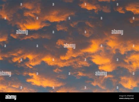 Orange Abstract Background Sky With Clouds Patterns In Late Afternoon