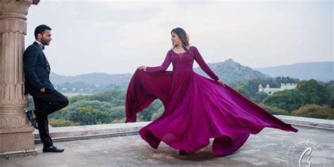 A Man Standing Next To A Woman In A Purple Dress