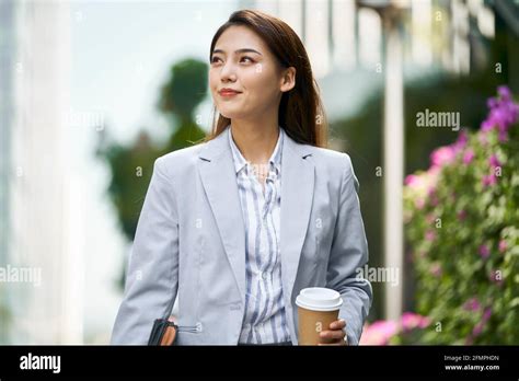 Successful Young Asian Female White Collar Office Worker Walking On