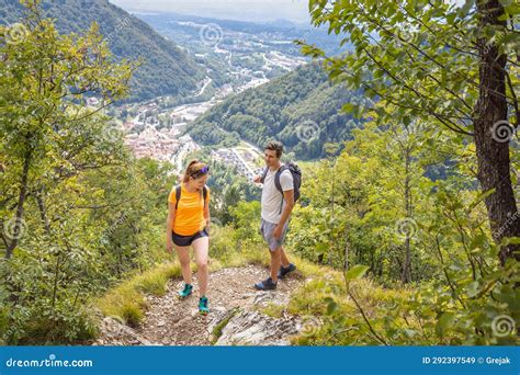 Hiking Couple Walking Uphill Along A Forest Trail On A Summer Day Stock