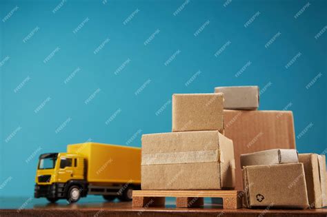 Premium Photo Yellow Container Truck With Pallet Of Cardboard Boxes