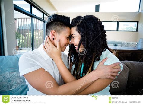 Lesbian Couple Embracing Each Other On Sofa Stock Photo Image Of