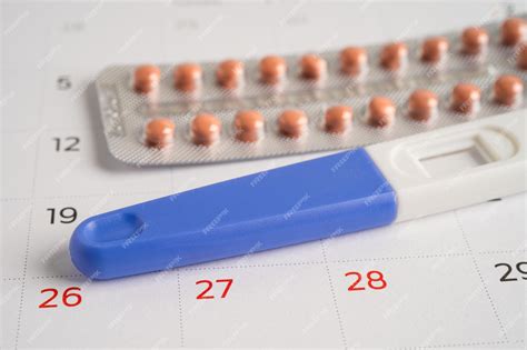 Premium Photo Pregnancy Test And Birth Control Pills On Calendar Contraception Health And Medicine