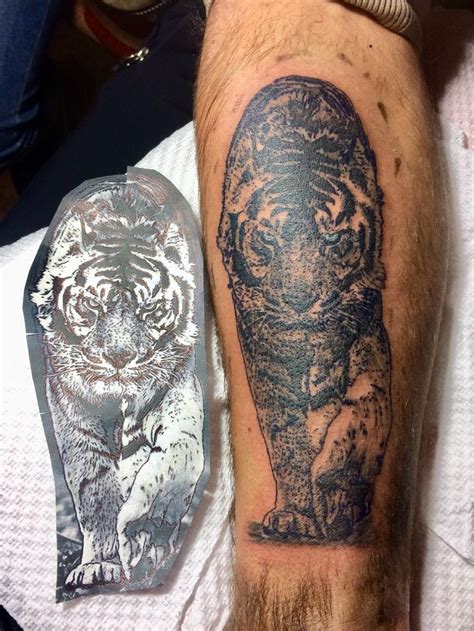 A Man With A Tiger Tattoo On His Arm