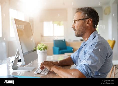 Mature Man Working From Home On Desktop Computer Stock Photo Alamy