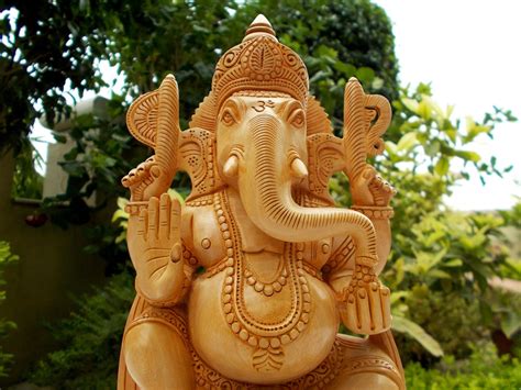 CraftVatika Wooden Ganesh Statue Hand Carved Sitting On Lotus Hindu