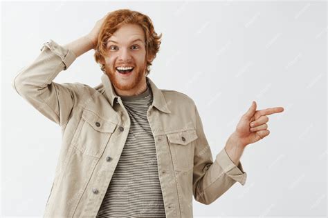 Free Photo Joyful Bearded Redhead Guy Posing Against The White Wall