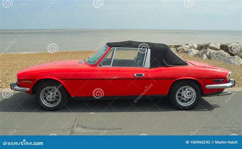 Classic Red Triumph Stag Motor Car Parked On Seafront Promenade