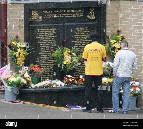 People visit the memorial for the victims of the Bradford City stadium fire on the 25th ...