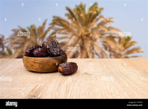 Dates fruit in bowl, background is date fruit tree Stock Photo - Alamy
