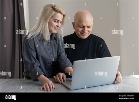 Smiling Mature Elderly Man Financial Documents And Laptop