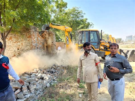 Free Photo Bulldozer Of Greater Noida Authority Runs In Patwari