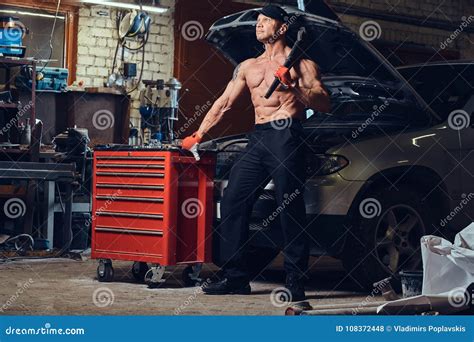 Shirtless Mechanic In A Garage Stock Photography CartoonDealer