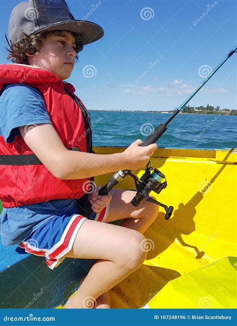 Kid Fishing from Small Dinghy on Tauranga Harbour. Stock Photo - Image ...