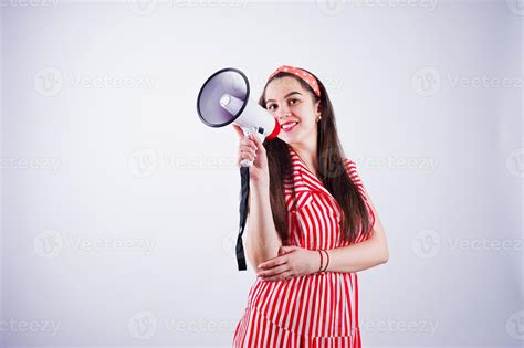 Portrait Of A Young Beautiful Woman In Red Dress Talking Into Megaphone