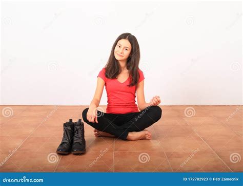 Smiling Girl Sitting On Floor By Black Shoes Stock Image Image Of