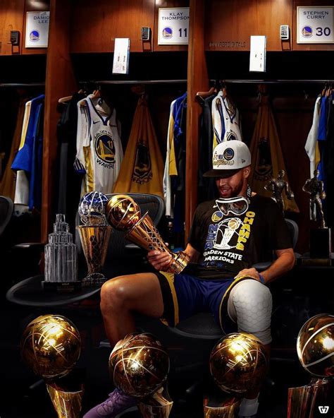 A Man Sitting On Top Of A Chair In Front Of Soccer Balls And Trophy Cups