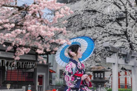 Asian Woman Wearing Japanese Traditional Kimono Sitting Among The