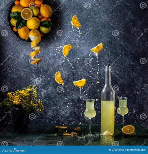 Limoncello In Bottle And Two Grappas Wineglass Fresh Lemon In Plate