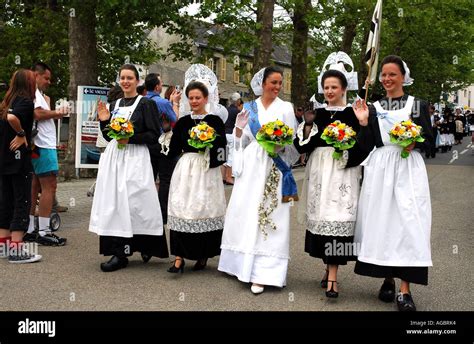 Young Women Wear Traditional Breton Costumes In A Summer Folklore