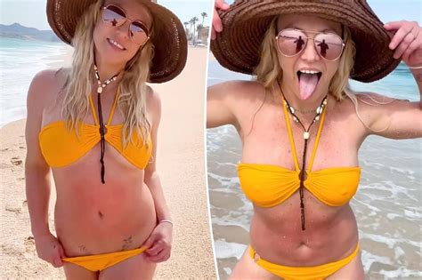 Britney Spears Frolics On The Beach In Bold Yellow Bikini