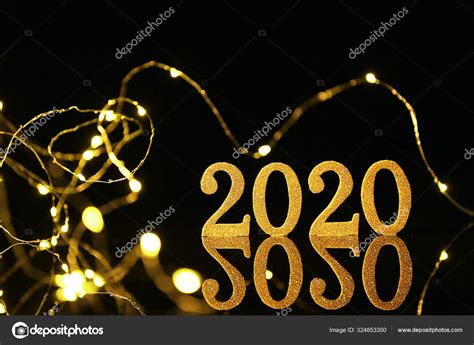 Figure 2020 and Christmas lights on dark background Stock Photo by ...