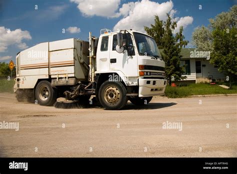 City Street Sweeper Cleaning Winter Gravel From The Roads Stock Photo