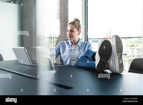 Casual Businesswoman Sitting Desk Feet Hi Res Stock Photography And