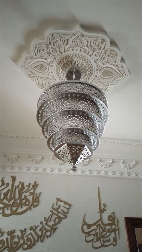 An Intricately Designed Light Fixture Hangs From The Ceiling In A Room