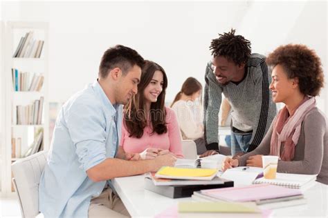 Multiethnic Group Of College Students Studying Together Stock Photo