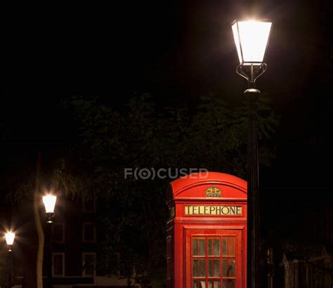 Red telephone box — retro, illuminated - Stock Photo | #172019574