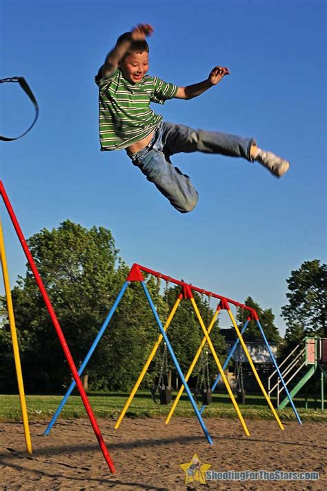 Boy Jumping From Swing At Playground