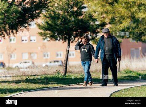 Grandfather Caring For His Grandson In The Park Stock Photo Alamy