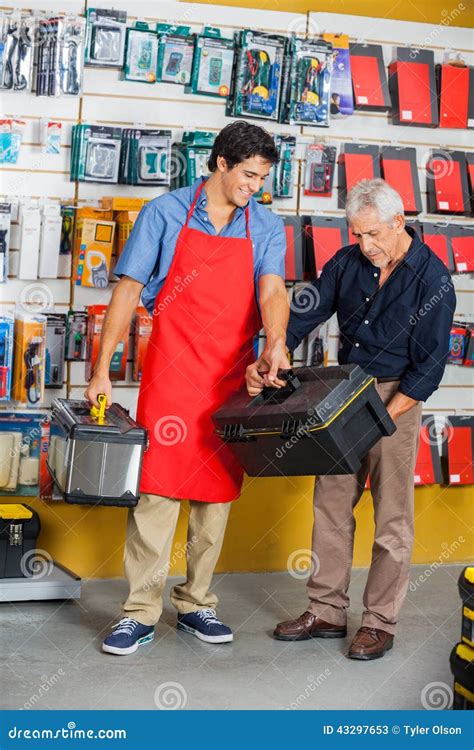 Salesman Assisting Man In Selecting Toolbox At Stock Image Image Of