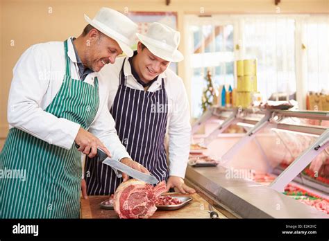 Butcher Teaching Apprentice How To Prepare Meat Stock Photo Alamy