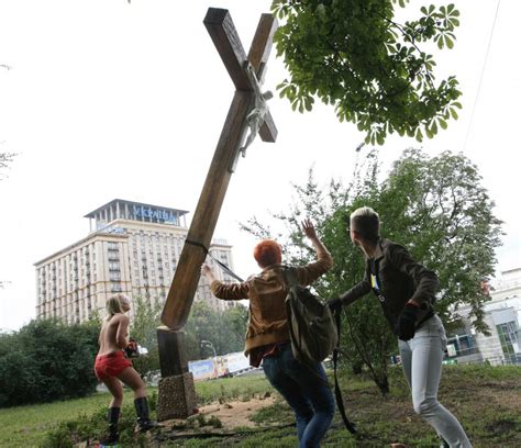 Pussy Riot Solidarity Protests Topless Lady With Chainsaw Cuts Down