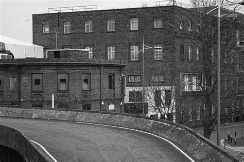 A Black And White Photo Of An Old Brick Building