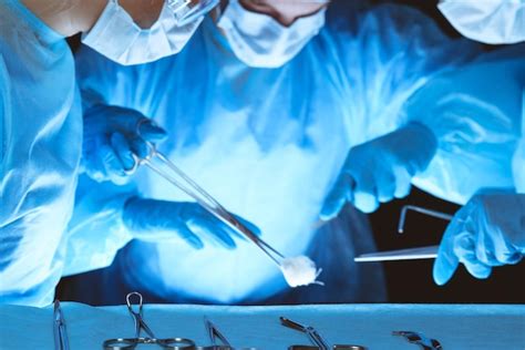 Premium Photo Group Of Surgeons Wearing Safety Masks Performing