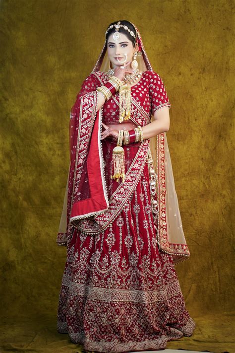 A woman in a red and gold wedding dress photo – Free Human Image on