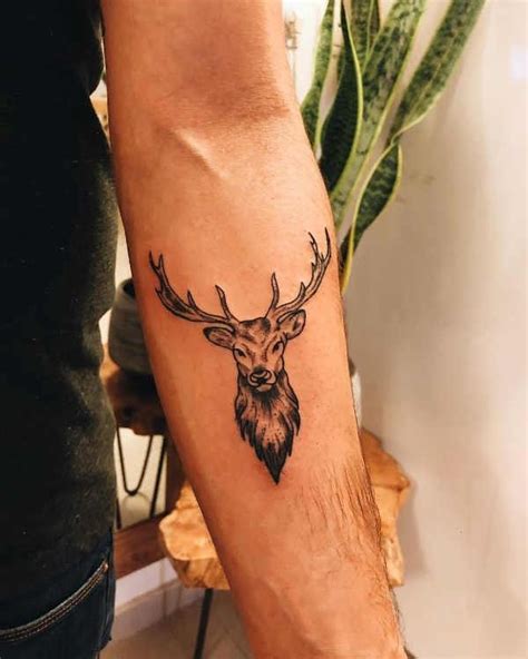 A Man With A Deer Head Tattoo On His Arm