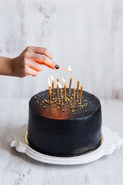 Woman Hand Burning Candles On Black Birthday Cake Stock Photo Image