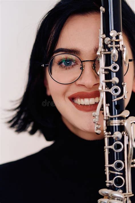Graceful Brunette Musician Posing With Clarinet On White Background