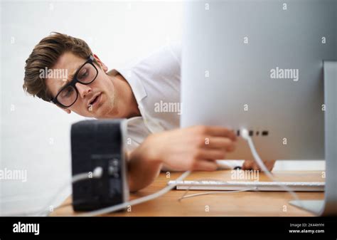 Ive Got This A Young Man Trying To Plug A Cable Into His Computer