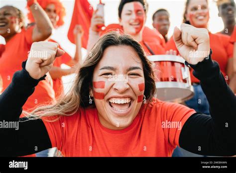 Latin Sport Fan Celebrating With Crowd Team With Stadium Background