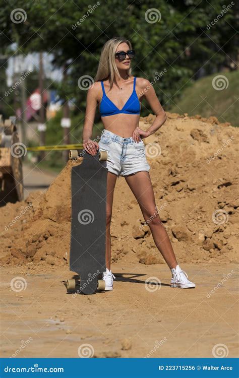 A Lovely Blonde Model Poses Outdoors In A Large City Environment Stock